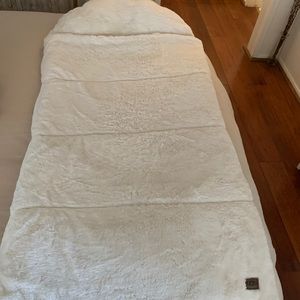 UGG sleeping bag for child. Plush white velvet material.